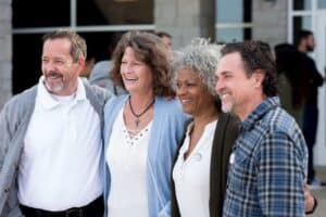 Schoolmates take a group photo at their 40 year reunion