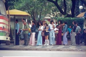 People Queue At A Bus Stop